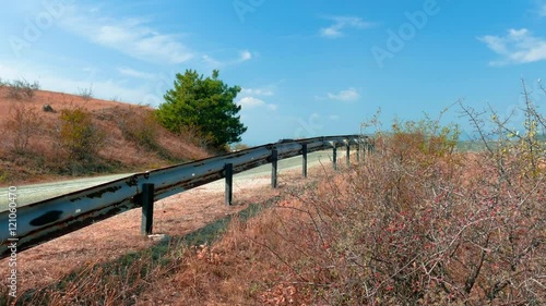 Suburban highway /Suburban highway, view from the roadside. Metal road barrier fences (bumpers)
