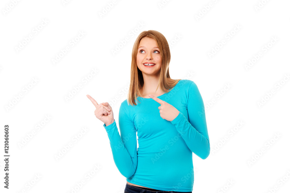 Young woman pointing with both hands Young woman pointing with both hands