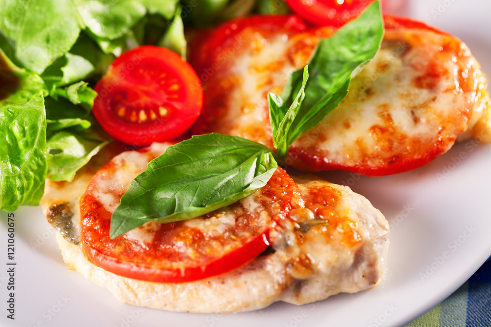 Chicken baked with mozzarella and tomatos served with fresh gree Chicken baked with mozzarella and tomatos served with fresh gree