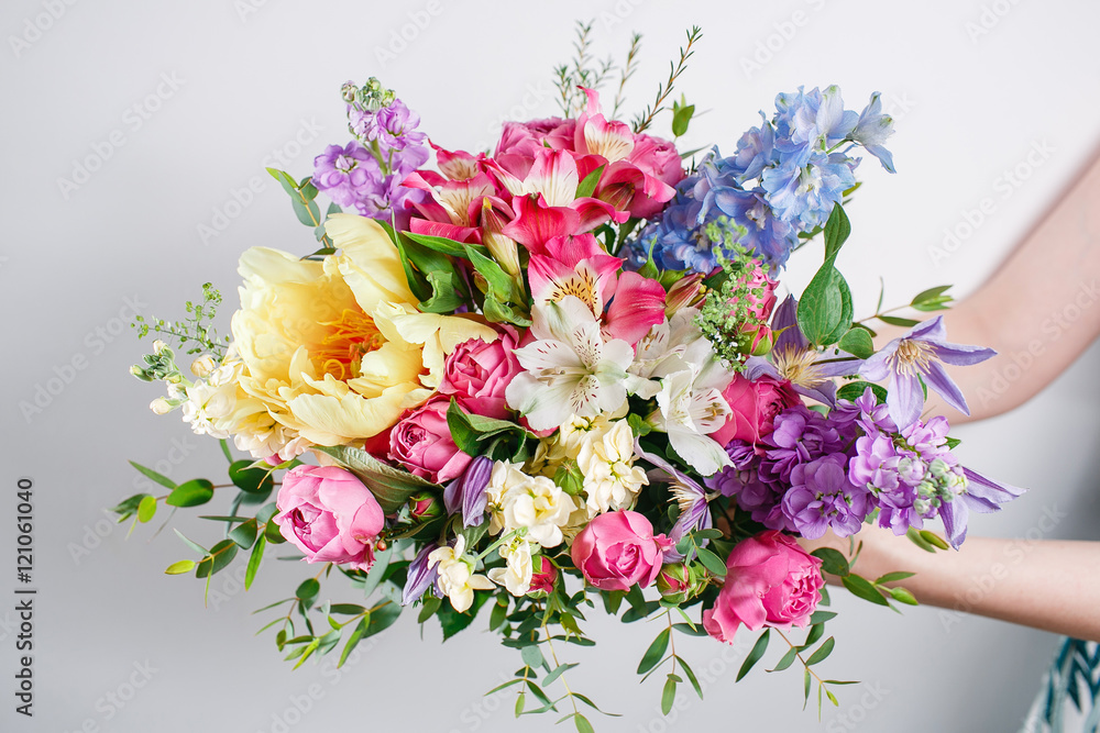 Luxury bouquets of mixed flowers in the hands women.