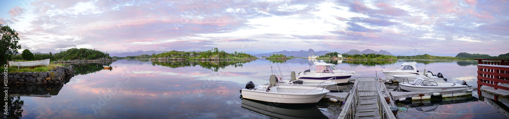Fototapeta premium Sunset on the Lofoten islands in Norway. Landscape with boats in the Norwegian fjords. 