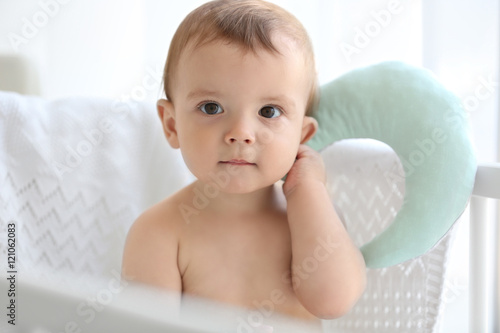 Cute baby sitting in the bed