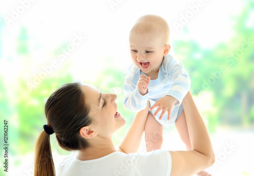 Mother and baby on light ba...