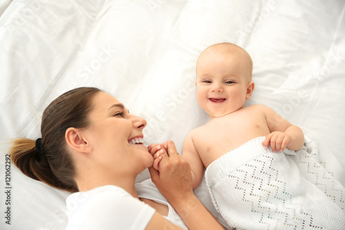 Mother and baby on bed