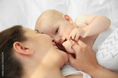Mother and baby on bed