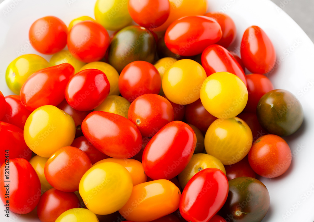 Tomatoes on the gray background. Colorful tomatoes, red tomatoes Tomatoes on the gray background. Colorful tomatoes, red tomatoes