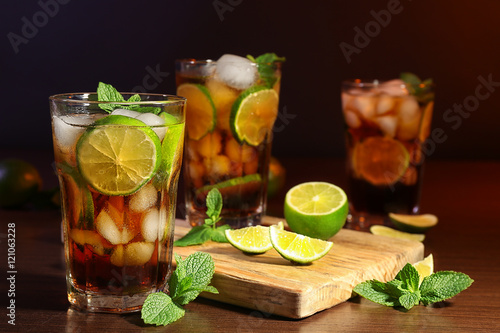Photography Kitchen board with cuba libre cocktails, lime and mint on wooden table