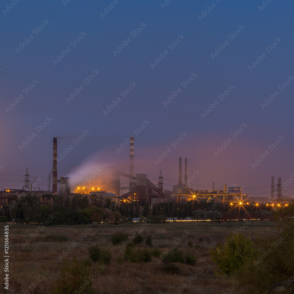 Picture of metallurgical plant and its Smoking chimneys in the background of clear sky Picture of metallurgical plant and its Smoking chimneys in the background of clear sky
