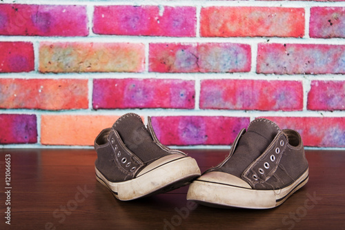 Old canvas shoes on a wooden floor