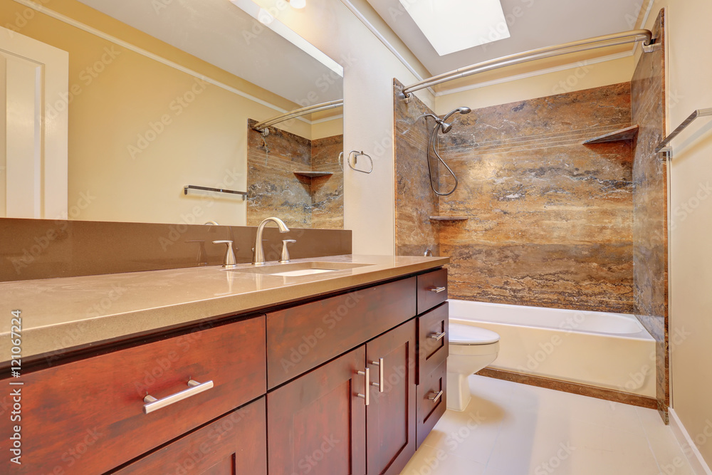 Bathroom interior with large vanity cabinet and mirror, tile floor Bathroom interior with large vanity cabinet and mirror, tile floor