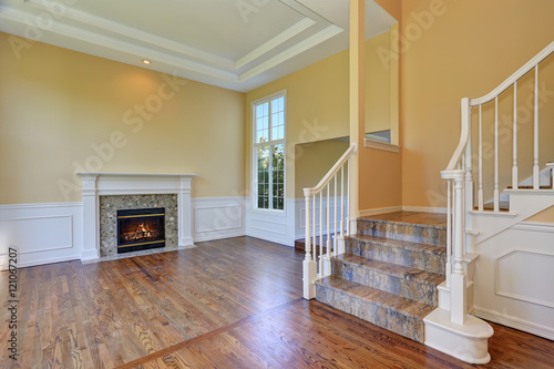 Open floor plan living room interior with hardwood floor and fireplace