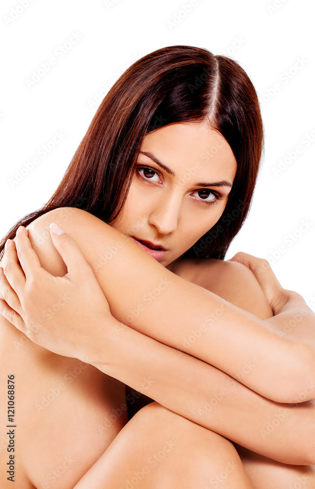 Young nude woman sitting on the floor Young nude woman sitting on the floor