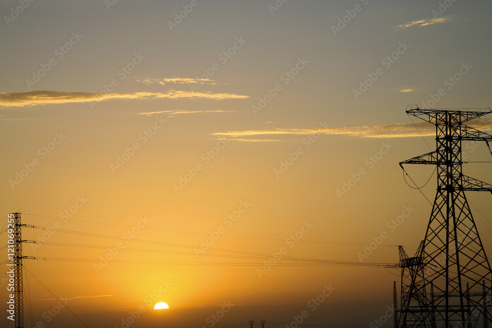 Silhouette of high voltage electrical pole structures in Namibia