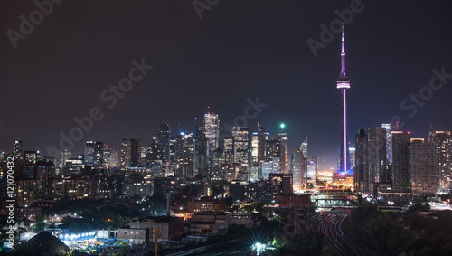 Urban lighted landscape of Toronto.   A balcony view of  lighted streets, parks, buildings and office towers on a hot & humid August night in capitol of Ontario, Canada. © valleyboi63