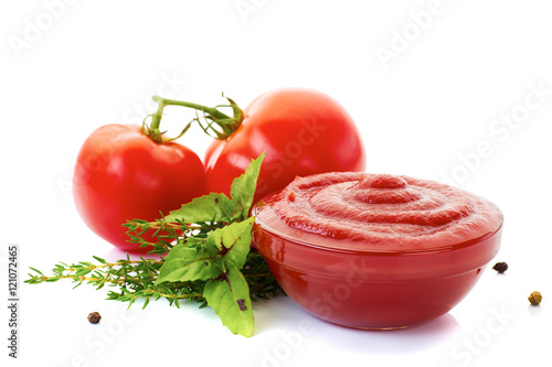 Bowl of ketchup or tomato sauce with ingredients on white