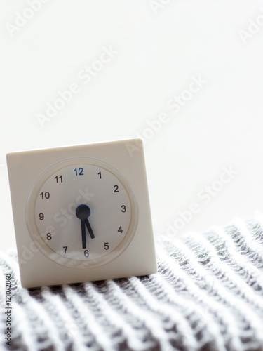 Series of a simple white analog clock on the blanket, 2/15