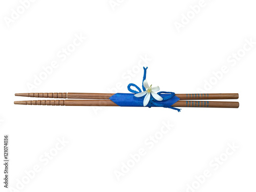 Wood chopstick and blue ribbon isolated on white background photo