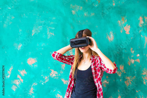 technology, VR, entertainment and people concept - happy young woman with virtual reality headset or 3d glasses © satura_