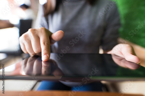 Woman typing tablet in cafe