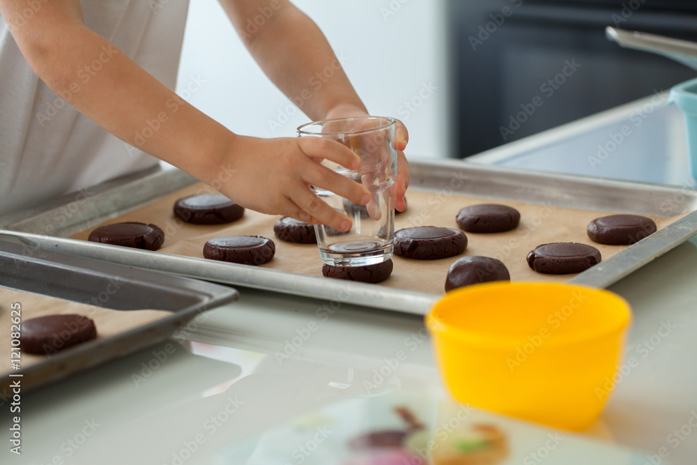 Cute little boy preparing Christmas cookies at home. Cute little boy preparing Christmas cookies at home.