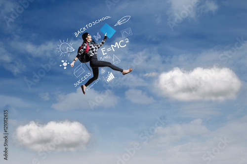 Female student jumps on the sky