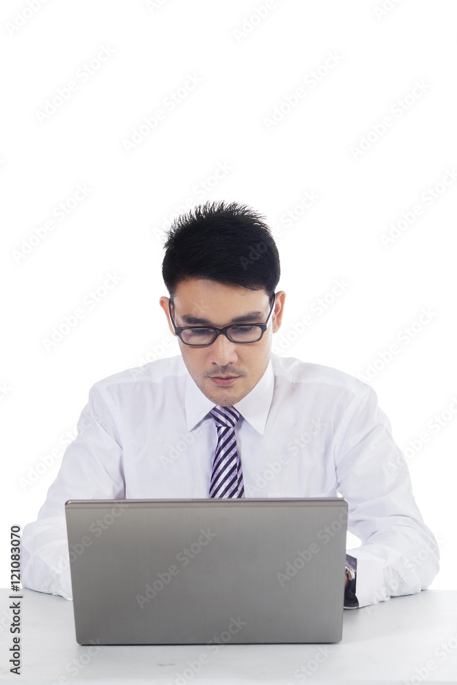 Male employee working seriously with laptop Male employee working seriously with laptop