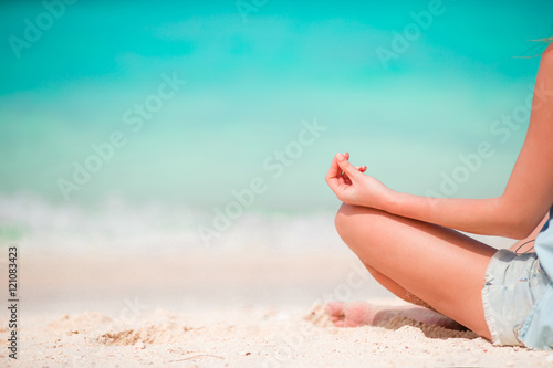 Body of beautiful woman in a meditation on the beach