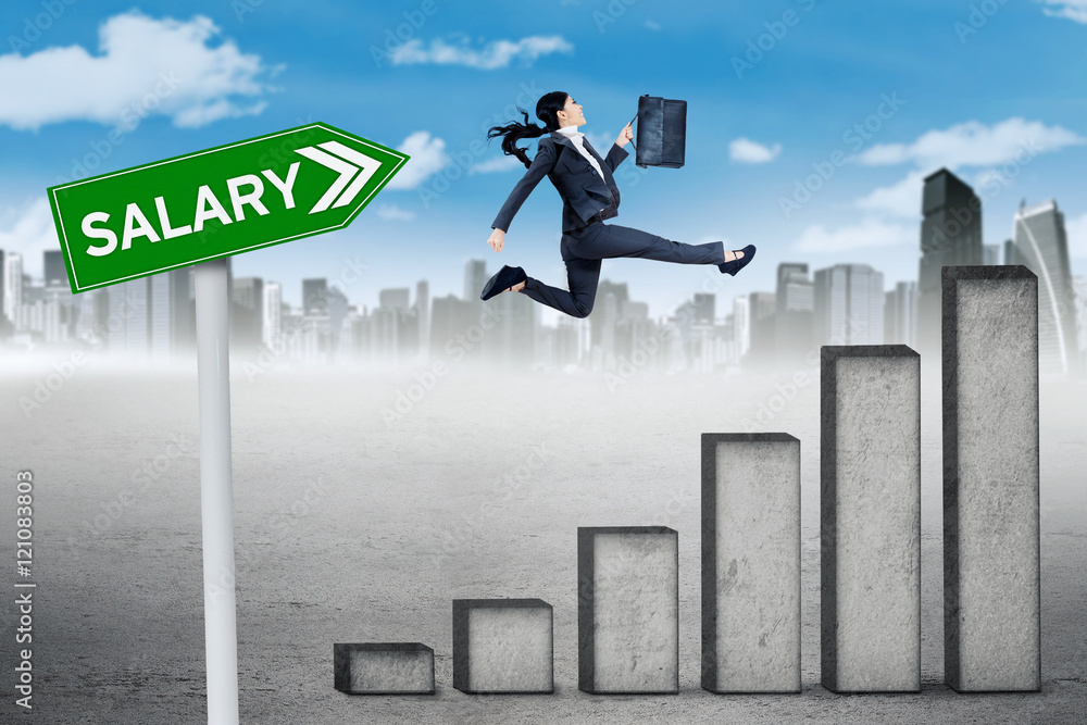 Worker jumps with chart and salary word Worker jumps with chart and salary word
