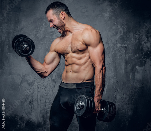  Muscular male doing biceps workouts.