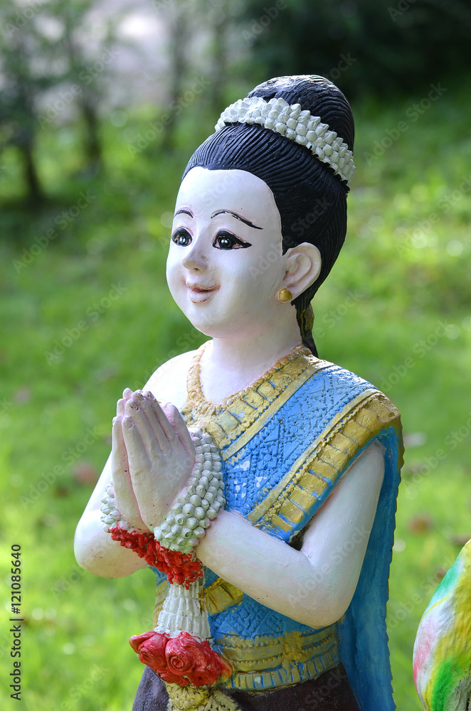 Sawasdee girl statue. Using for greetings and goodbye for Thais.