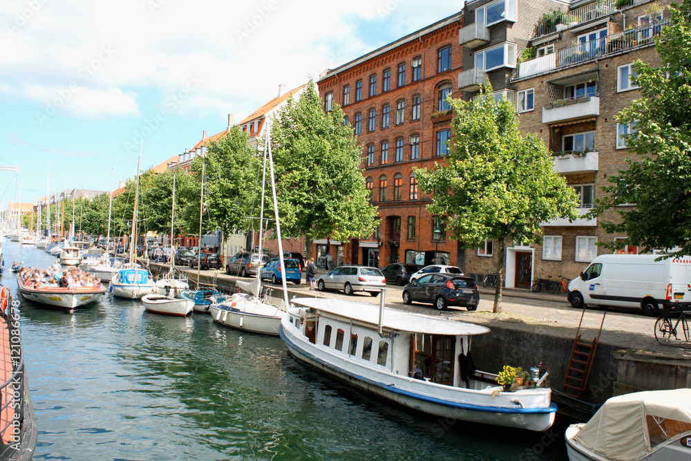 Scenic summer view of color buildings and water canals in Copehnagen.