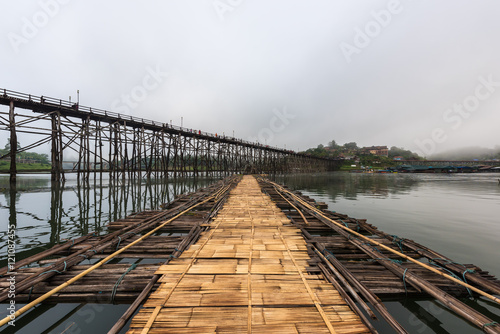 Wooden bridge over the river (Mon Bridge) in Sangkhlaburi District, Kanchanaburi, Thailand. © yotrakbutda