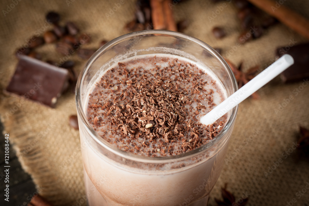 Photo of fresh Made Chocolate Banana Smoothie on a wooden table with coffee and spices. Selective focus. Milkshake. Protein diet. Healthy food concept. Drink, coffee beans, chocolate, Photo of fresh Made Chocolate Banana Smoothie on a wooden table with coffee and spices. Selective focus. Milkshake. Protein diet. Healthy food concept. Drink, coffee beans, chocolate,