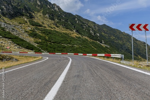 Winding mountain road with dangerous curves in Carpathian mountains. Transfagarasan road in Romania.