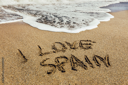 The words I Love Spain written in the sand on beach