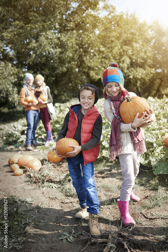 Happy family looking for Halloween pumpkins