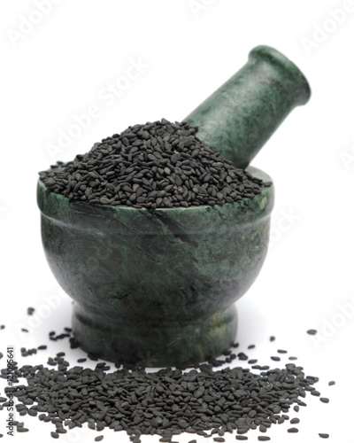 Organic Black Sesame (Sesamum indicum) on marble pestle and over white background. photo