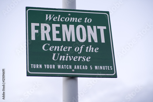 Welcome to Fremont - Center of the Universe - Turn Your Watch Ahead 5 Minutes Green and White Traffic Sign at the Entrance to the Fremont Neighborhood of Seattle, Washington, USA