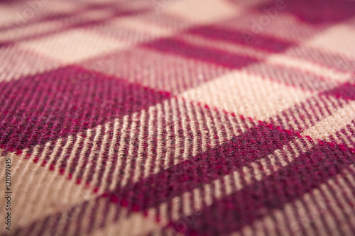 warm blanket. The pattern strips intersect. Maroon stripes. The texture of the blanket. Background