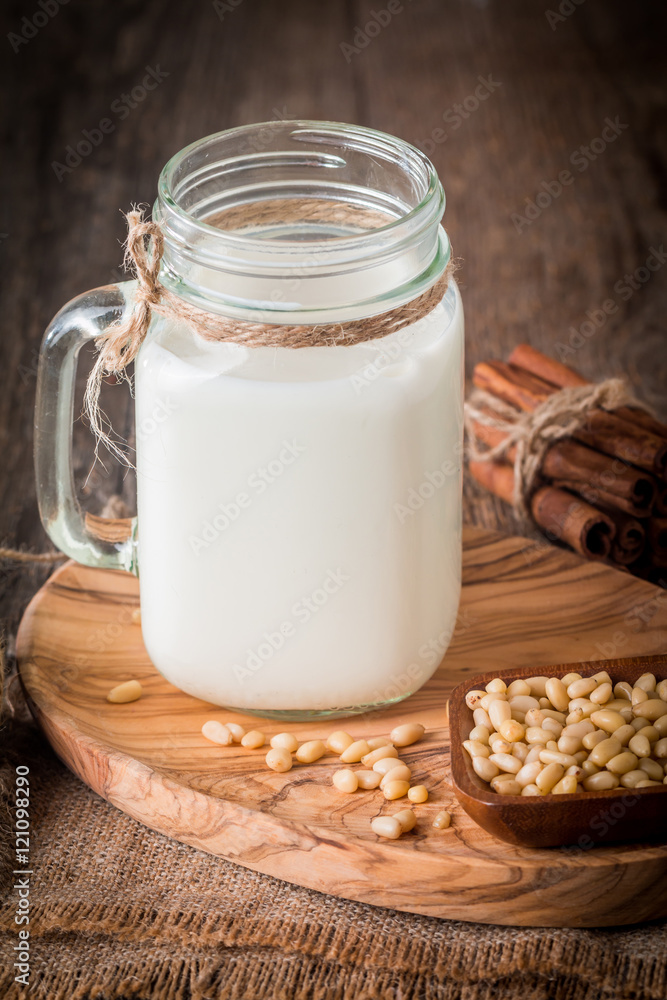 cedar milk in a glass jar and pine nuts cedar milk in a glass jar and pine nuts