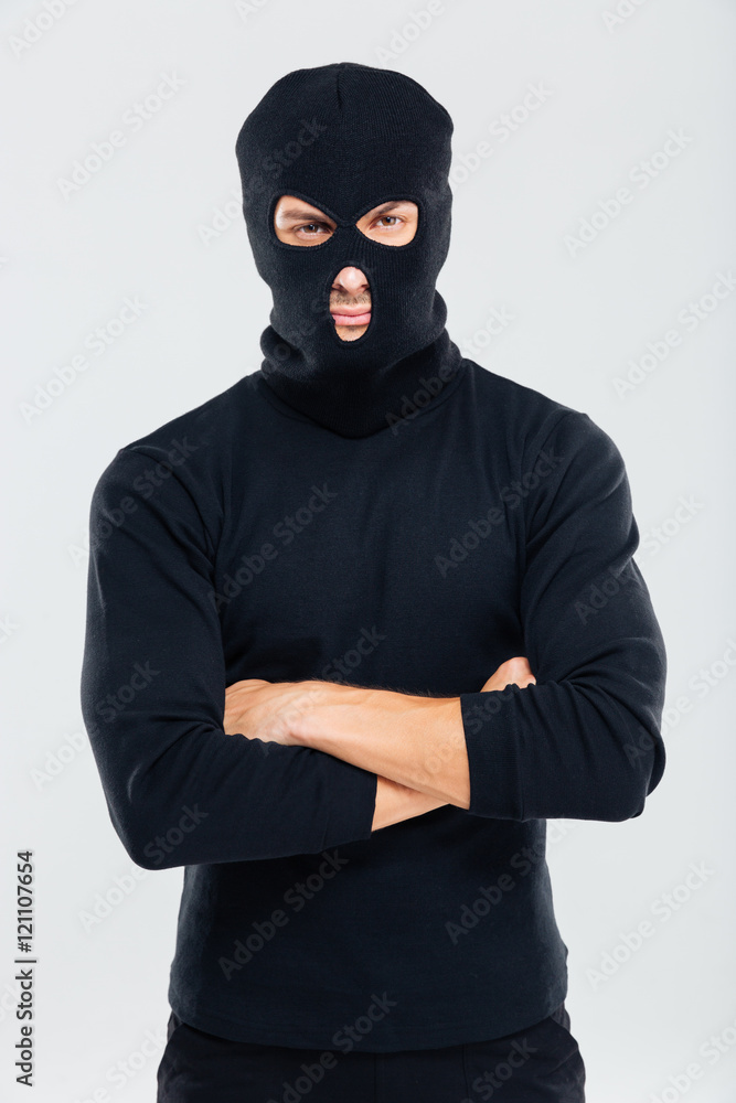 Portrait of man in balaclava standing with arms crossed Portrait of man in balaclava standing with arms crossed