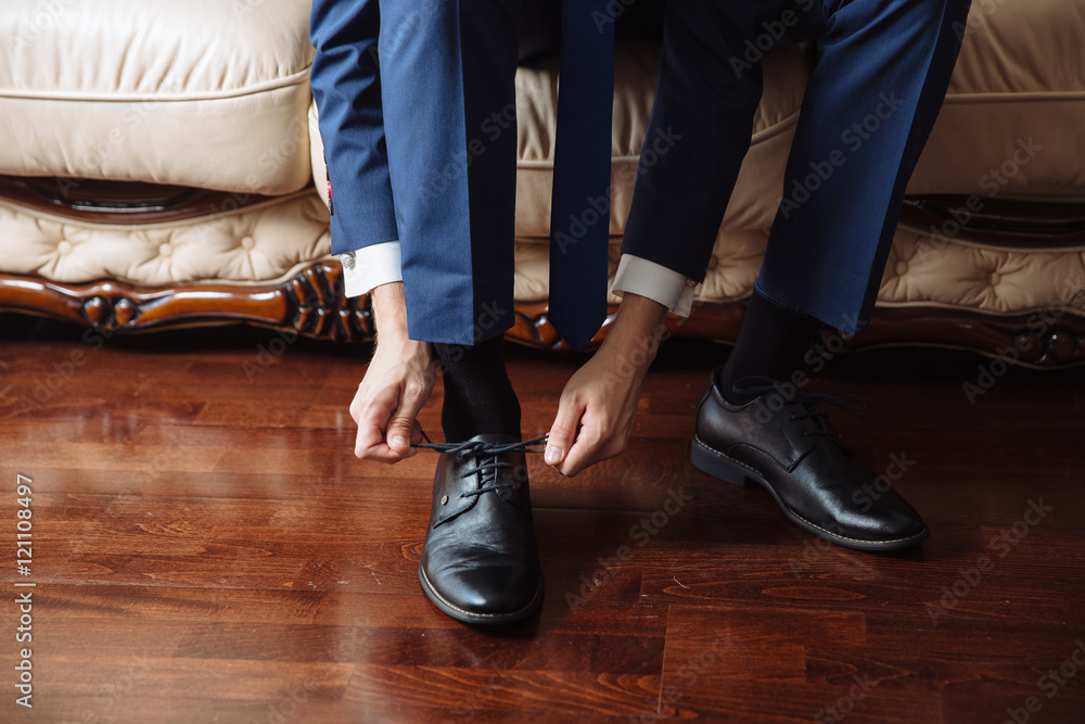 Business man dressing up with classic, elegant shoes. Groom wearing on wedding day, tying the laces and preparing. Business man dressing up with classic, elegant shoes. Groom wearing on wedding day, tying the laces and preparing.
