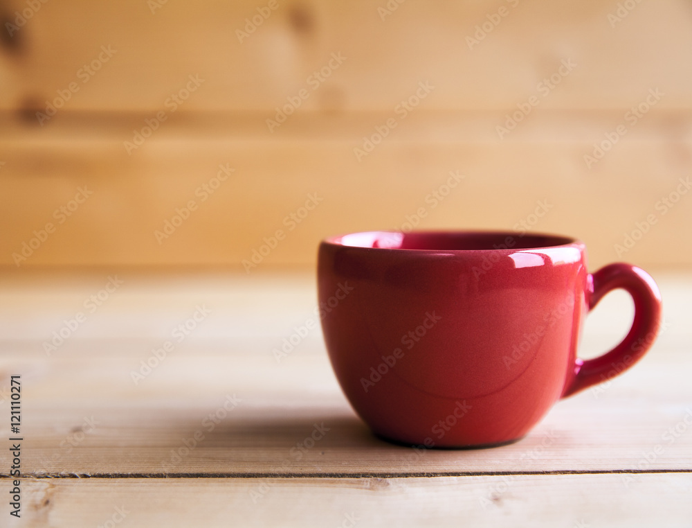 Red coffee cup on wooden table Red coffee cup on wooden table