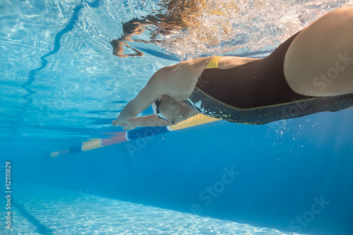 Girl swims in crawl style underwater