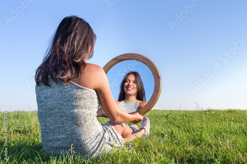 Woman in nature viewing her mirror image