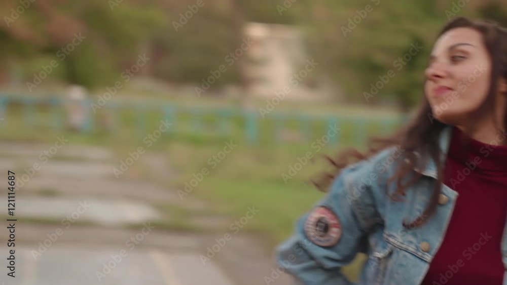 Beautiful brunette girl walking at the city park close-up Beautiful brunette girl walking at the city park close-up