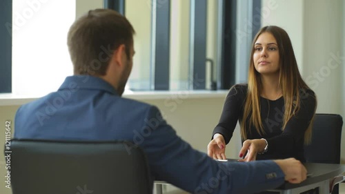 a woman answers questions of the employer at the interview