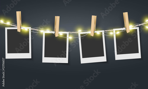 Blank photo frame hanging on rope with fairy lights Vector
