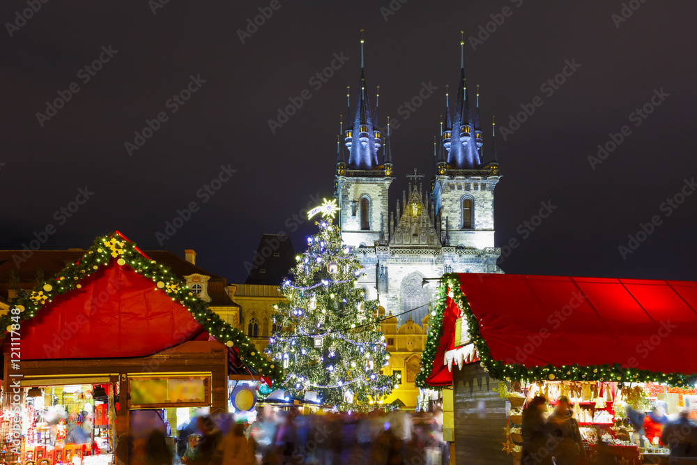 Old Town Square with Christmas tree and fairy tale Church of our Lady Tyn in the magical city of Prague at night, Czech Republic