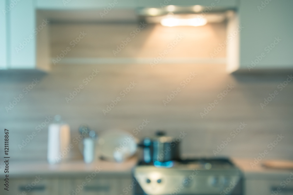 Blurred background. Modern kitchen with cooking on gas and space for you. Toned image.